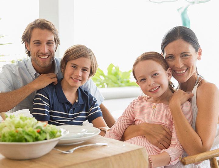 Portrait happy family eating lunch at patio table